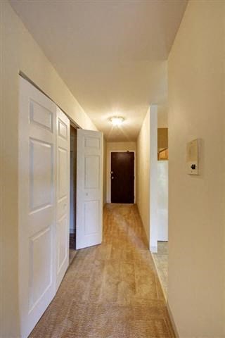 a hallway with two doors and a door to a bedroom