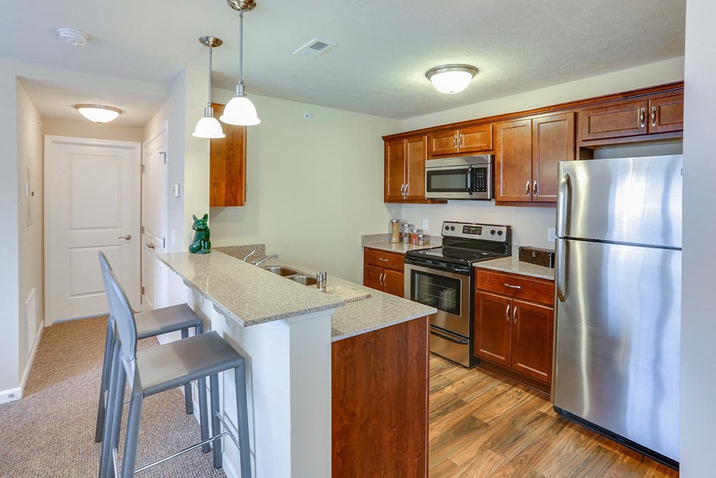 a kitchen with stainless steel appliances and a counter top