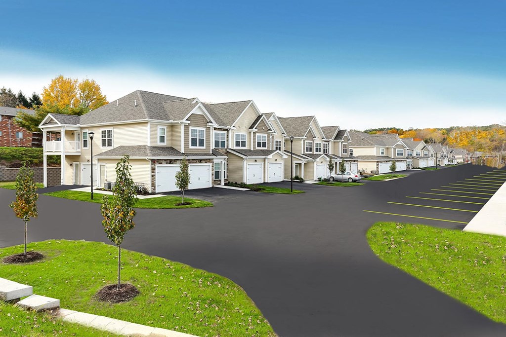 a row of houses on a street with green grass