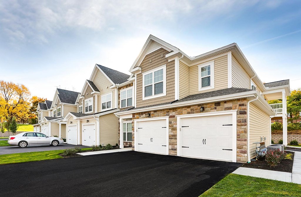 a tan and with white garage doors
