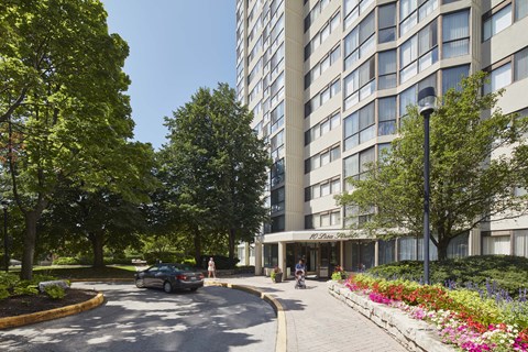 a city street with a building and a car on the road