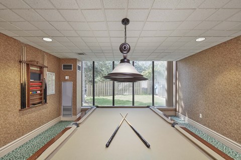a room with a ping pong table in the middle of it