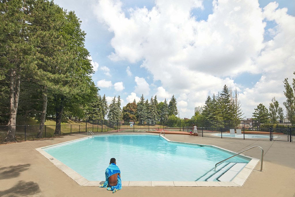 a person sitting in front of a swimming pool