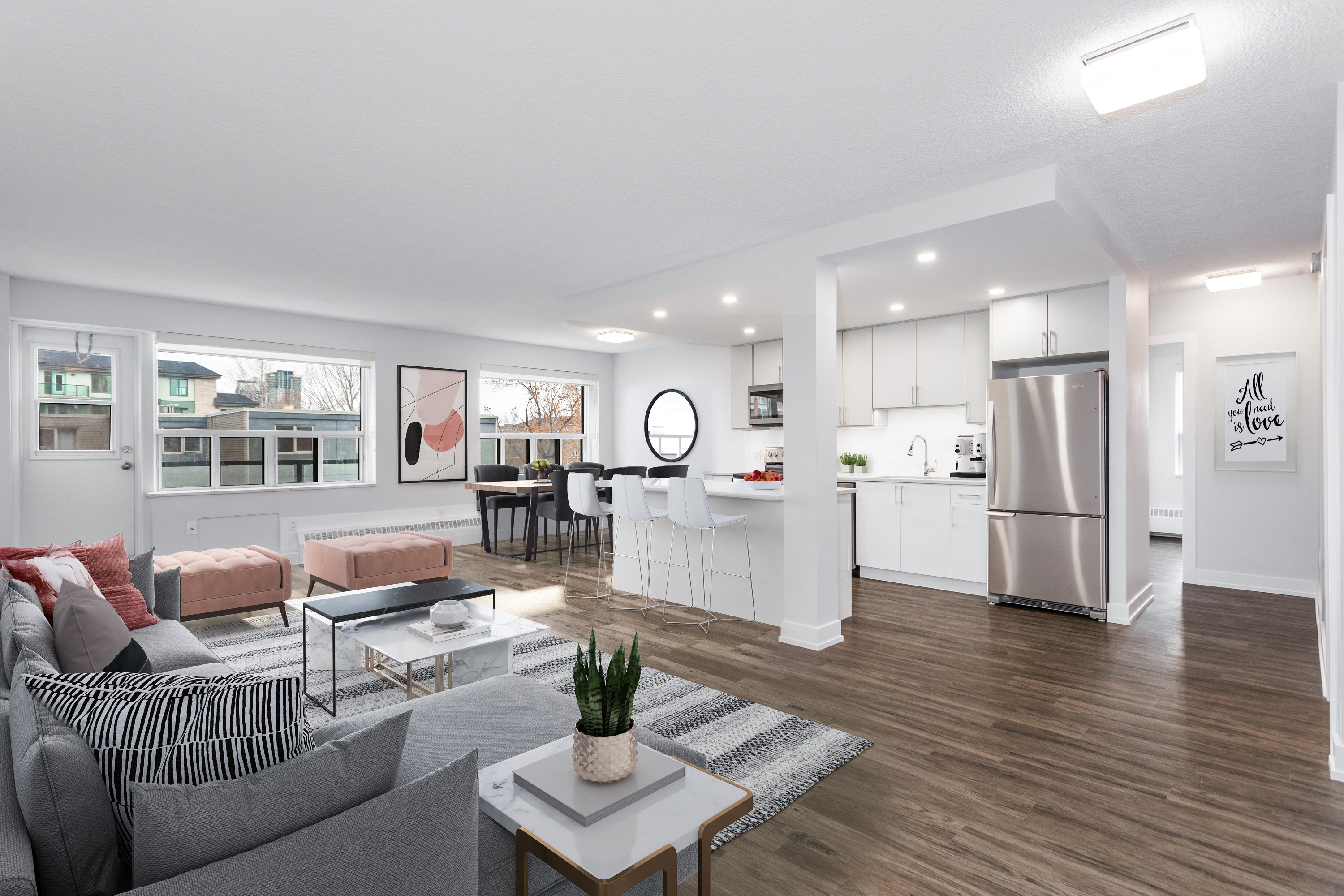 living room and dining room with a couch, area rug, table, dining table and an open concept kitchen