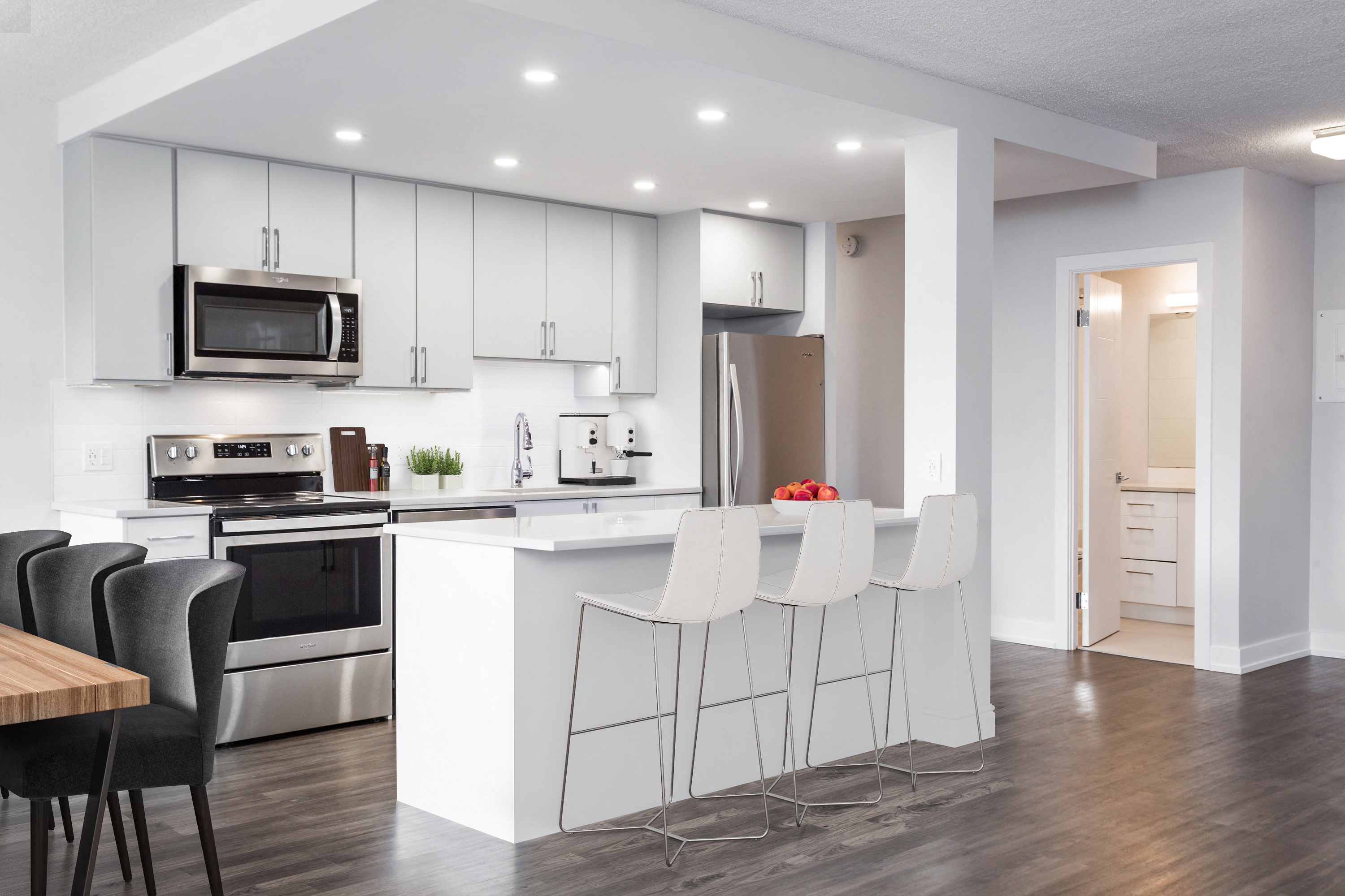 kitchen with island and bar stools, microwave, stove and fridge