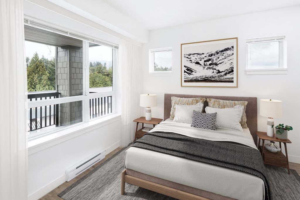 a bedroom with a bed and a large window