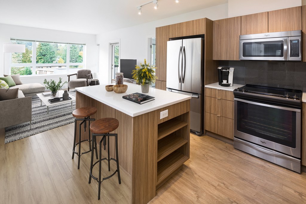 a kitchen with a center island with two stools