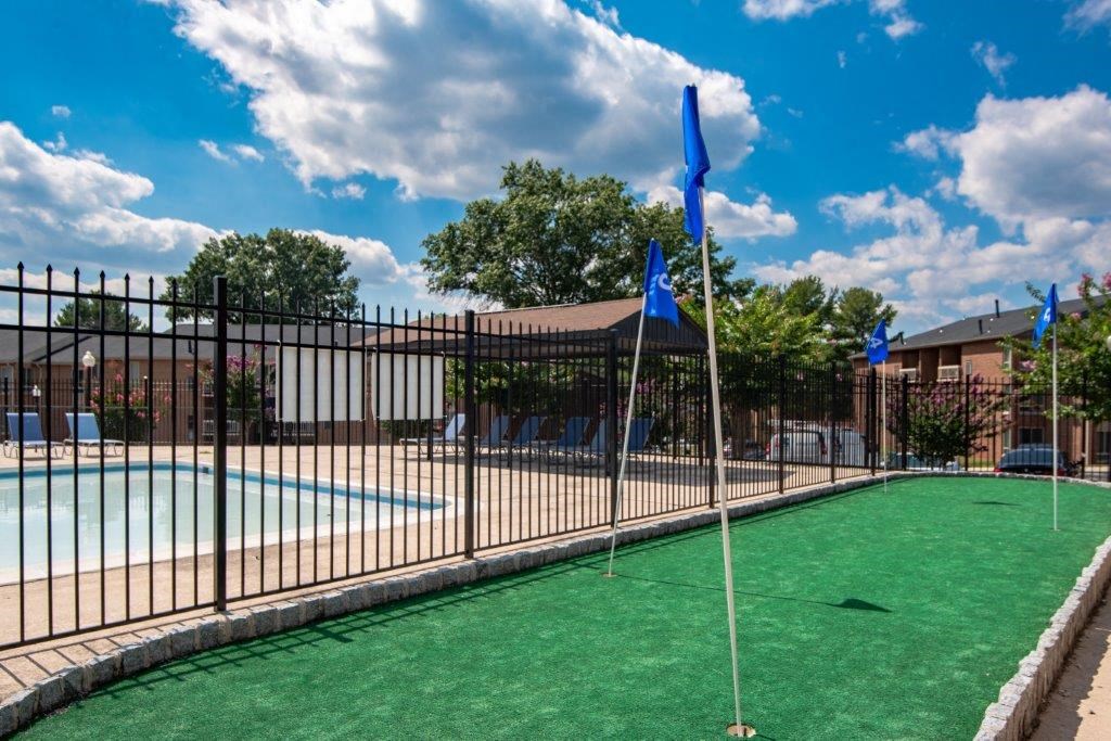 a pool with a fence and flags on top of it