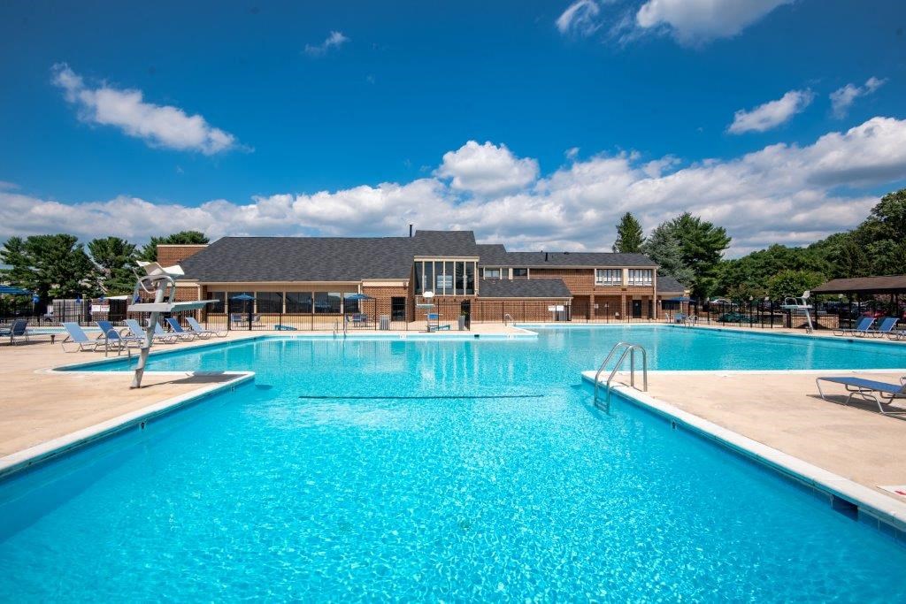 a large swimming pool with a building in the background