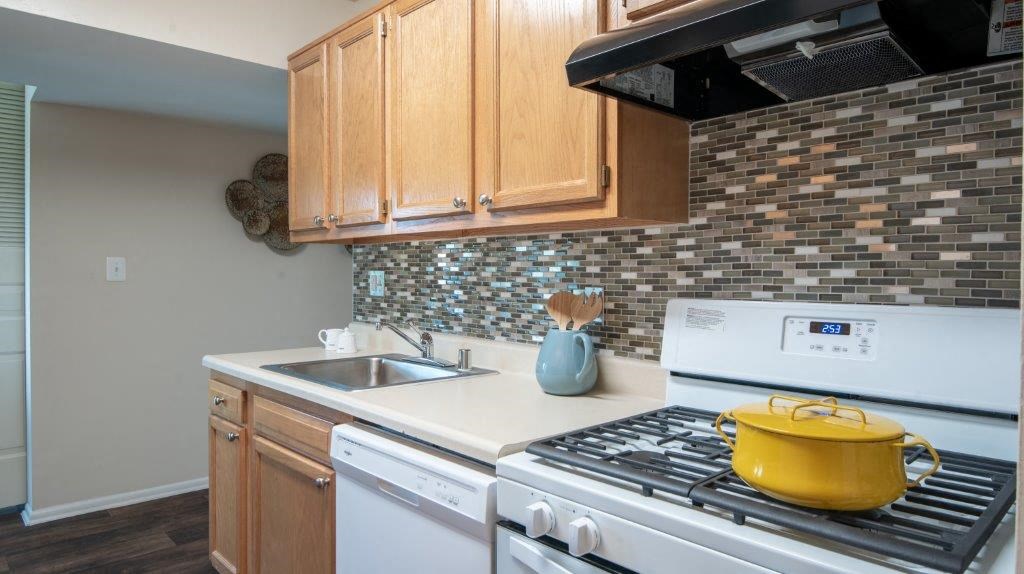 a kitchen with a stove top oven and a sink