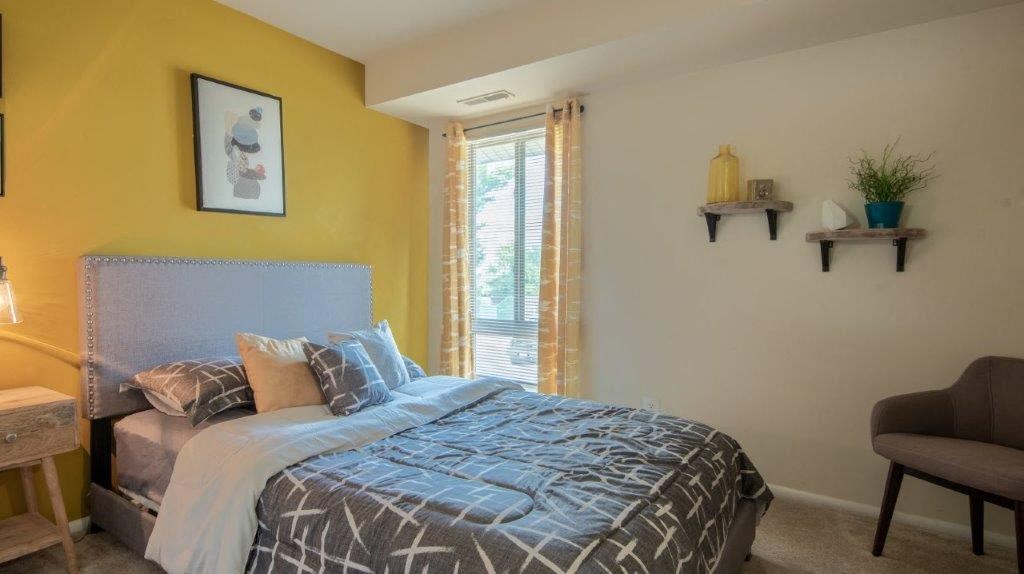 a bedroom with a bed and a window