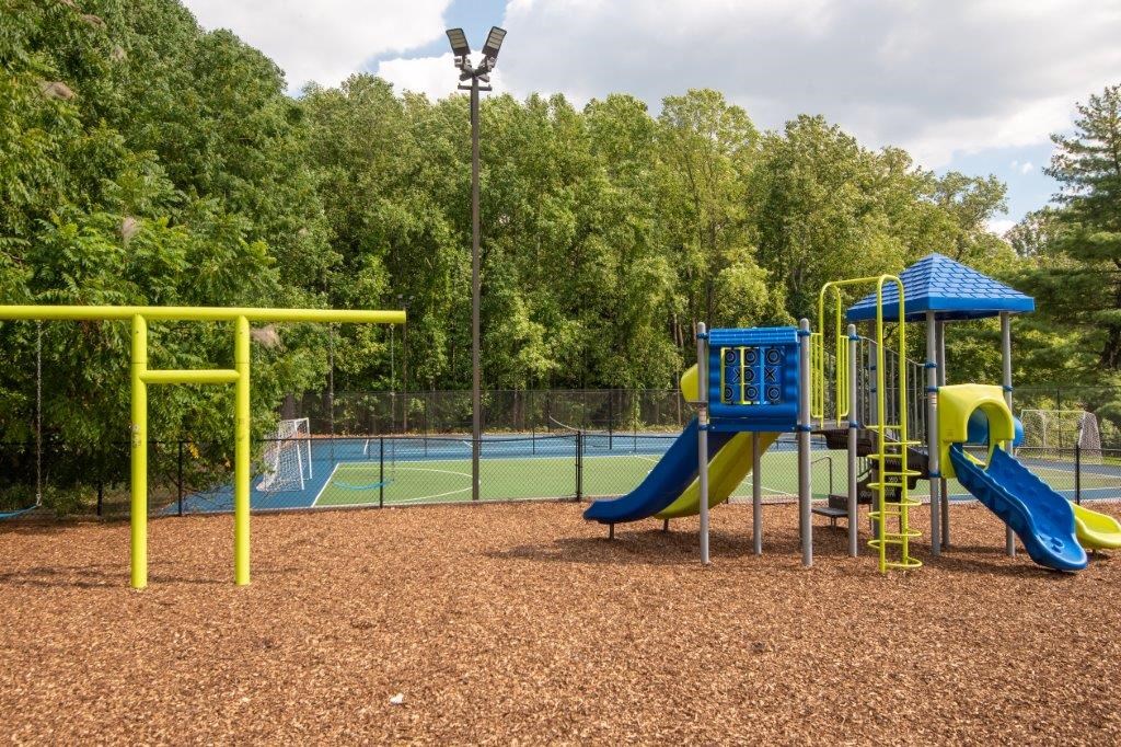 a playground with slides and a tennis court