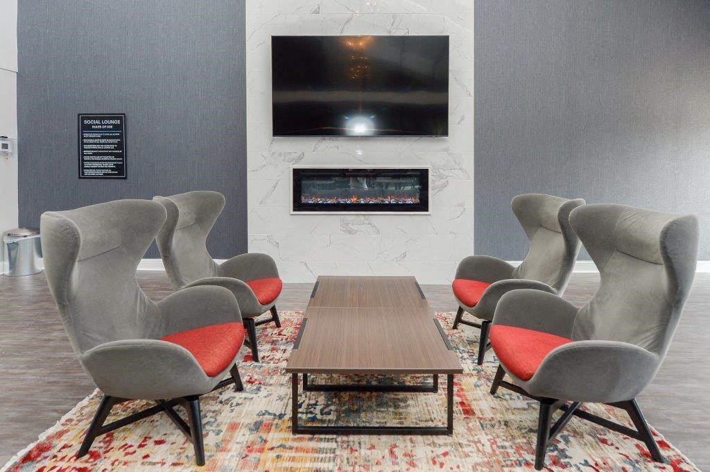 a conference room with a table and chairs and a television