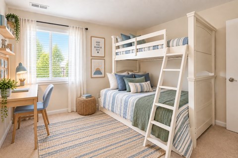 A cozy bedroom with a bunk bed and a desk.