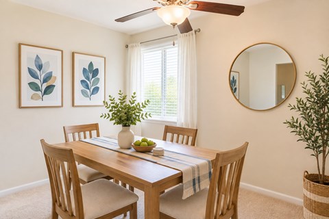 A dining room with a wooden table and chairs.