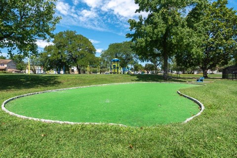 a park with a green circle in the grass