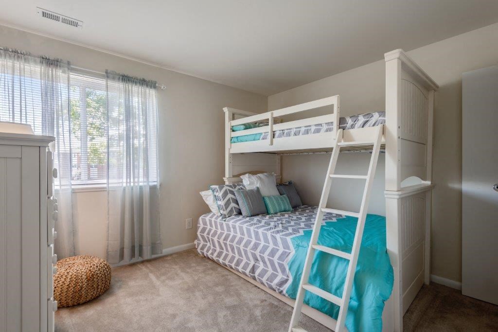 a bedroom with a bunk bed and a ladder