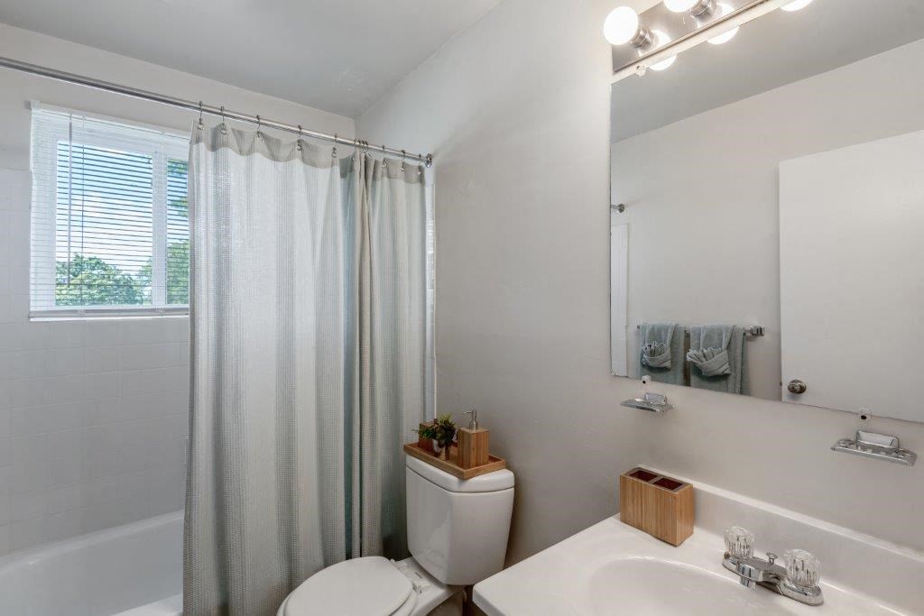 a bathroom with a sink toilet and a shower