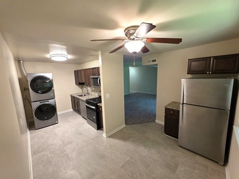 A kitchen with a refrigerator, microwave, and dishwasher.