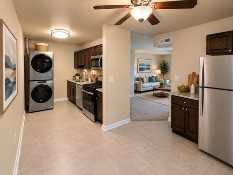 A kitchen with a refrigerator, oven, and microwave.