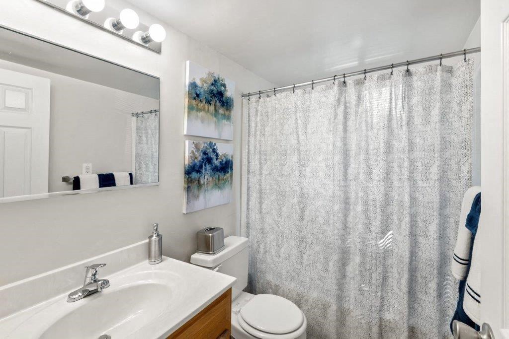 a bathroom with a sink toilet and a shower