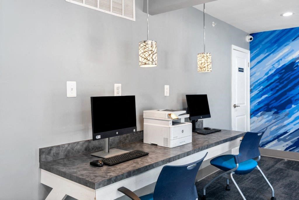 a home office with two computer monitors on a desk