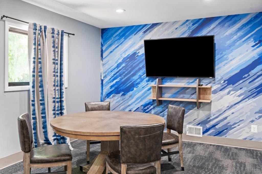 a dining room with a table and chairs and a television