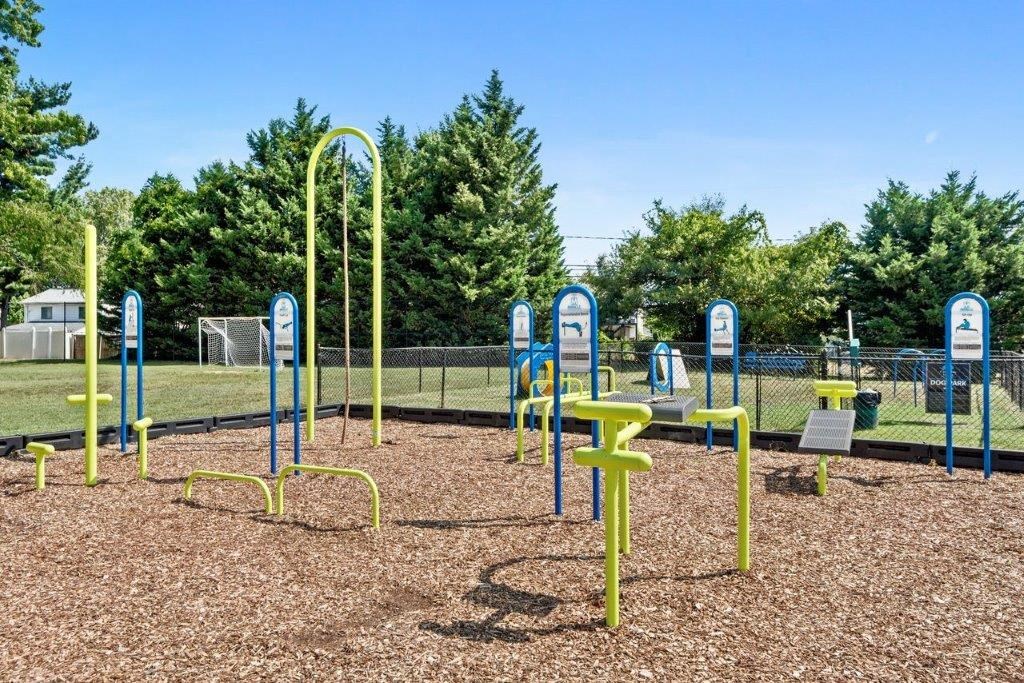 the playground is equipped with a variety of playground equipment