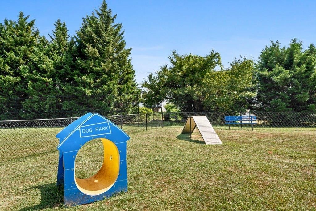 a park with a seesaw and a slide in the grass