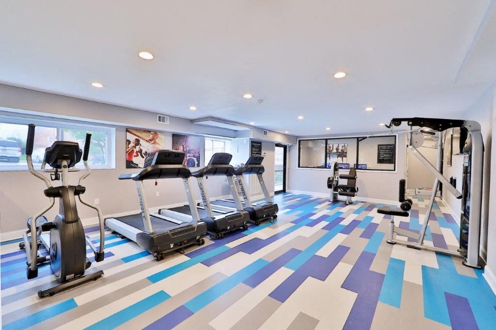 a gym with treadmills and weights on the floor