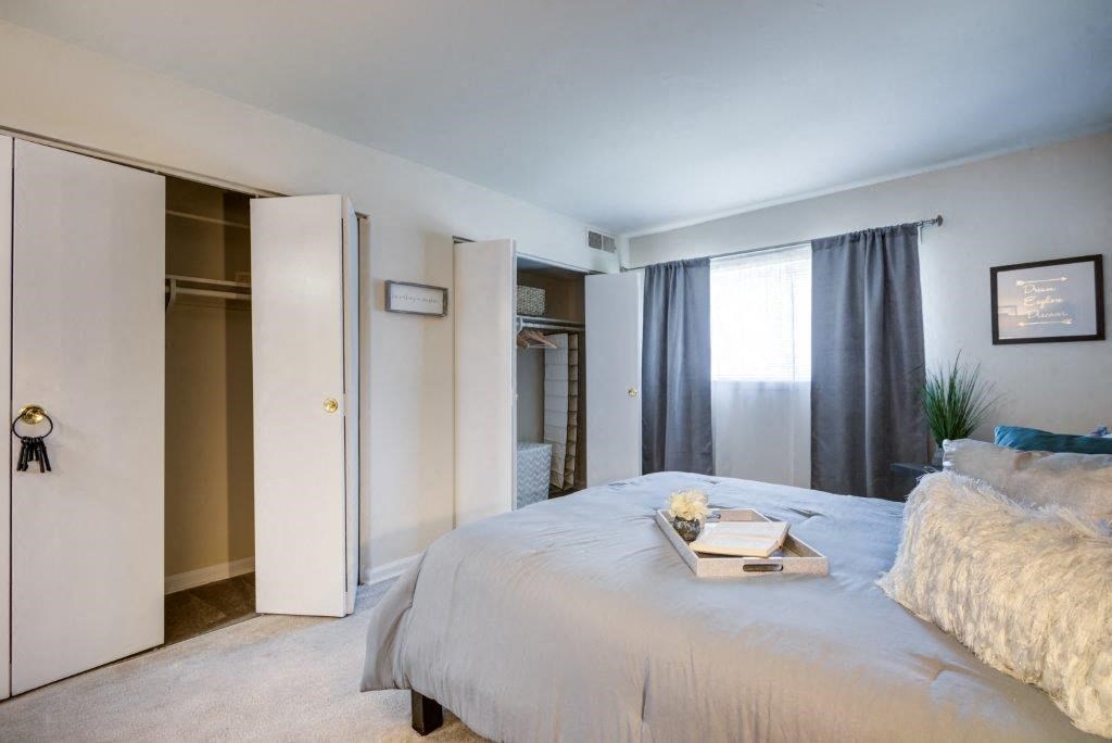 a bedroom with a large bed and a closet