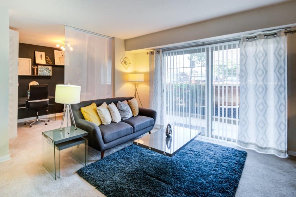 a living room with a couch and a glass table