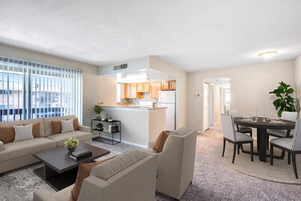 a living room and kitchen with a couch and a table