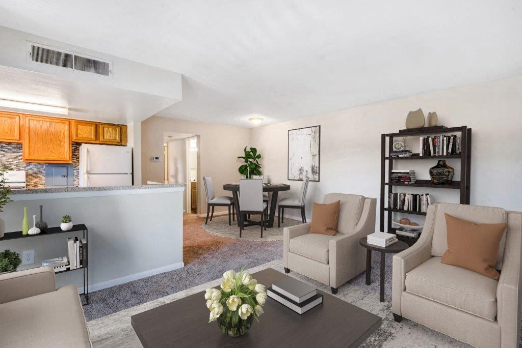 a living room and kitchen with a table and chairs