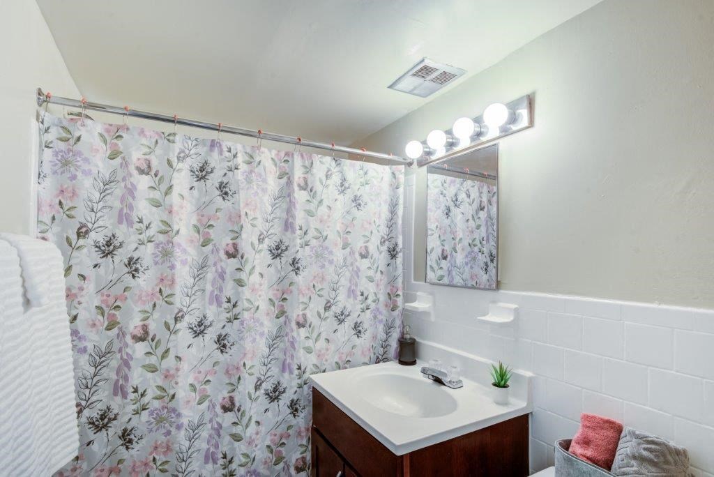 a bathroom with a shower curtain and a sink