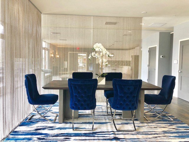 a dining room with blue chairs and a wooden table