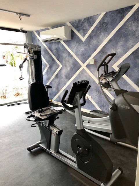 a gym with some exercise machines in it