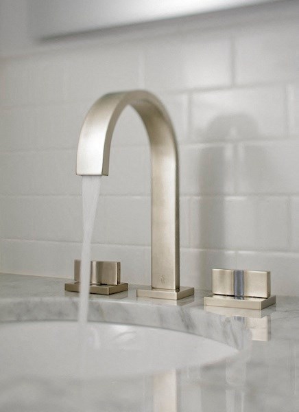 a close up of a bathroom sink with a water faucet