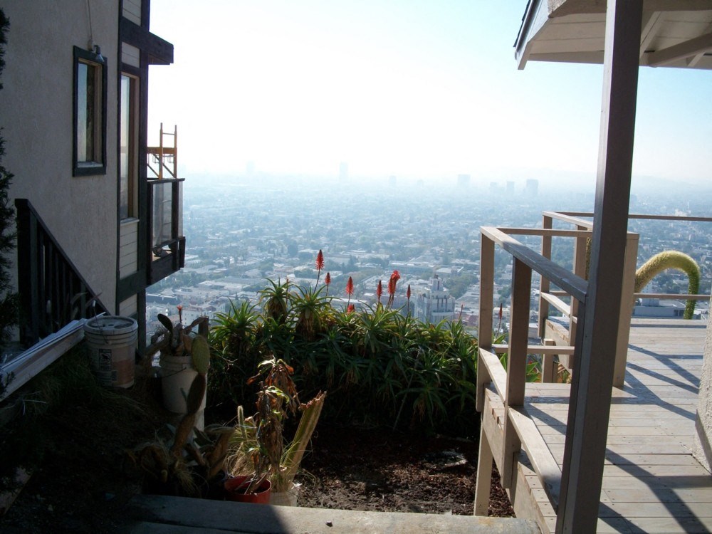 A balcony with a view of a cityscape.