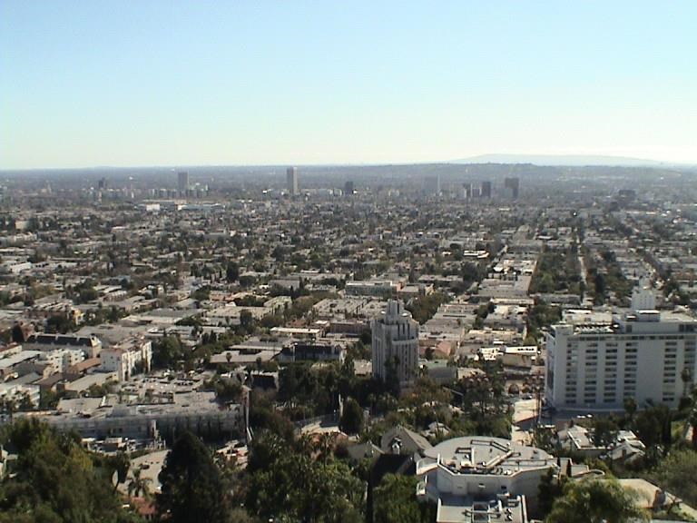 A cityscape with buildings and a clear sky.
