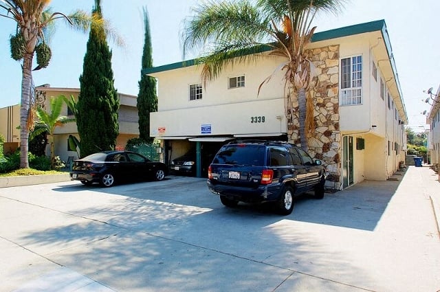 a building with two cars parked in front of it