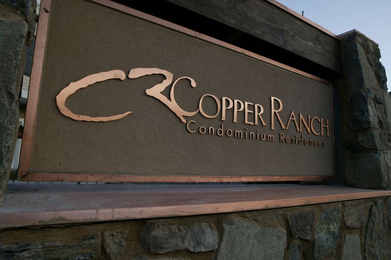 a sign for the copper ranch condominium residences