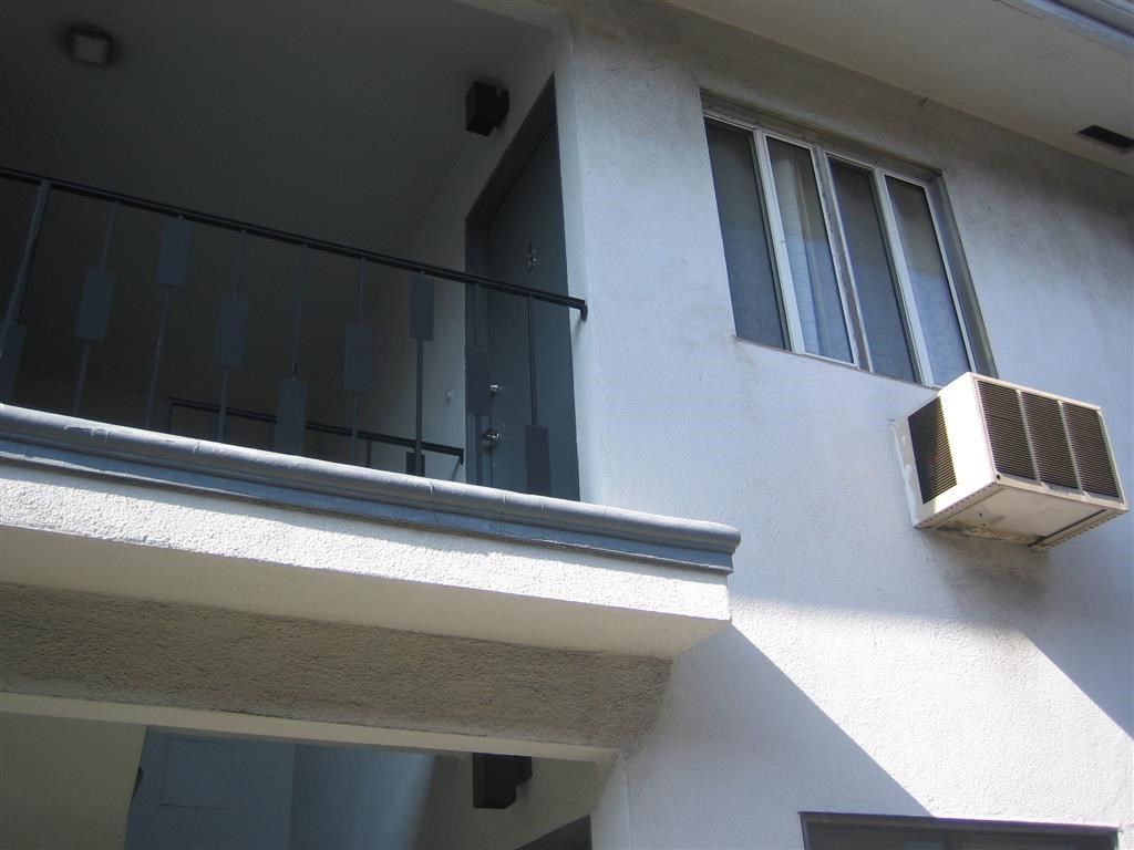 an air conditioning unit on the side of an apartment building