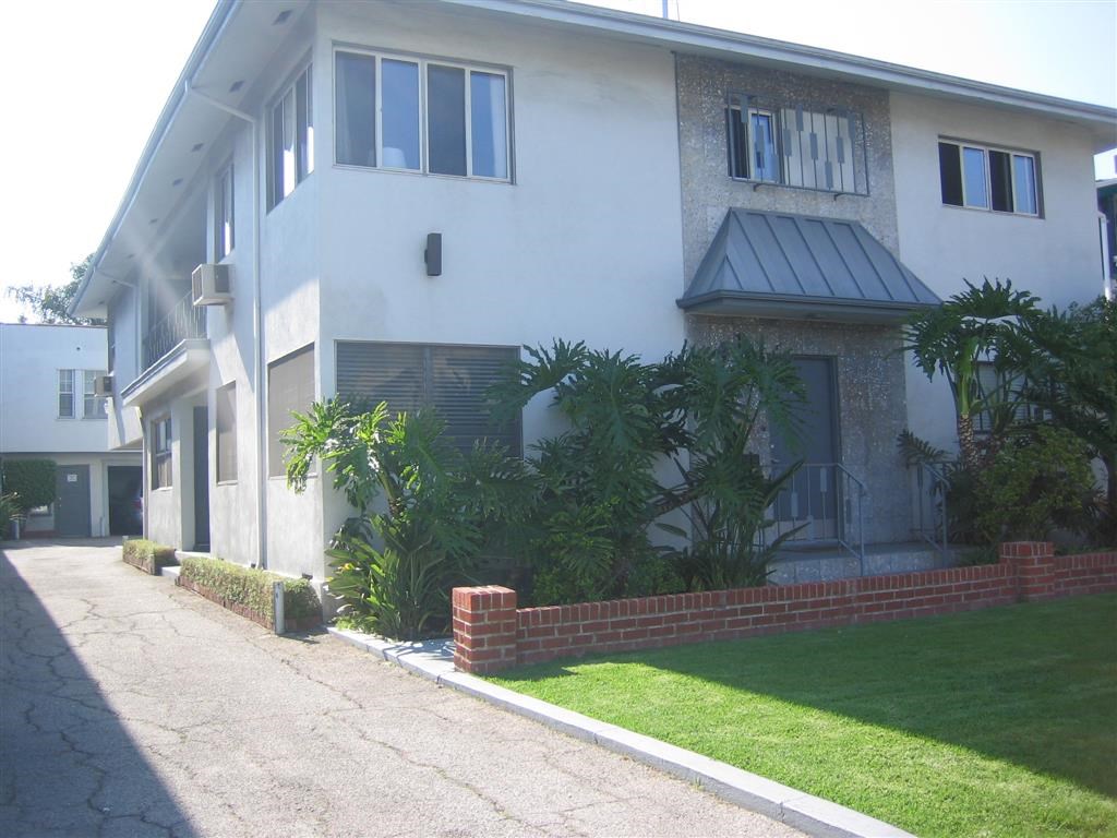 a white house with a yard and a sidewalk