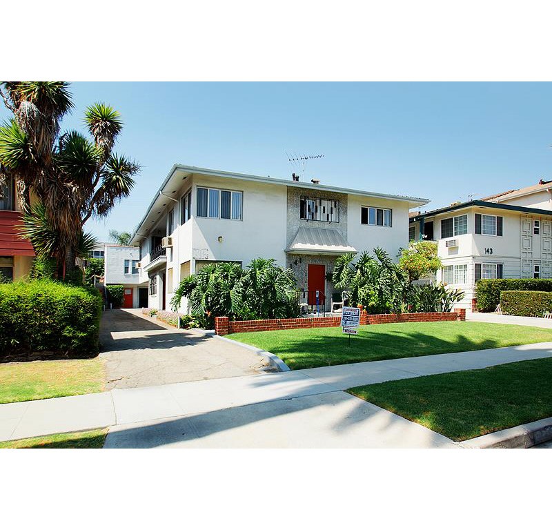 a white house with a sign in front of it