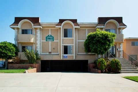 an apartment building with a driveway in front of it