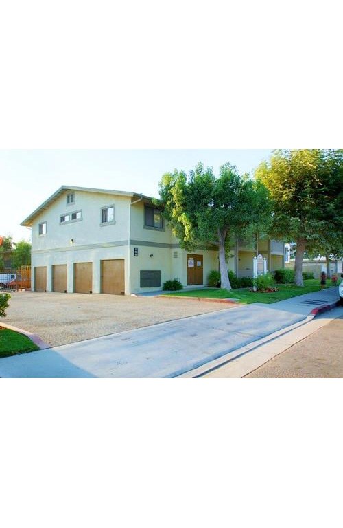 a large white house with trees in front of it