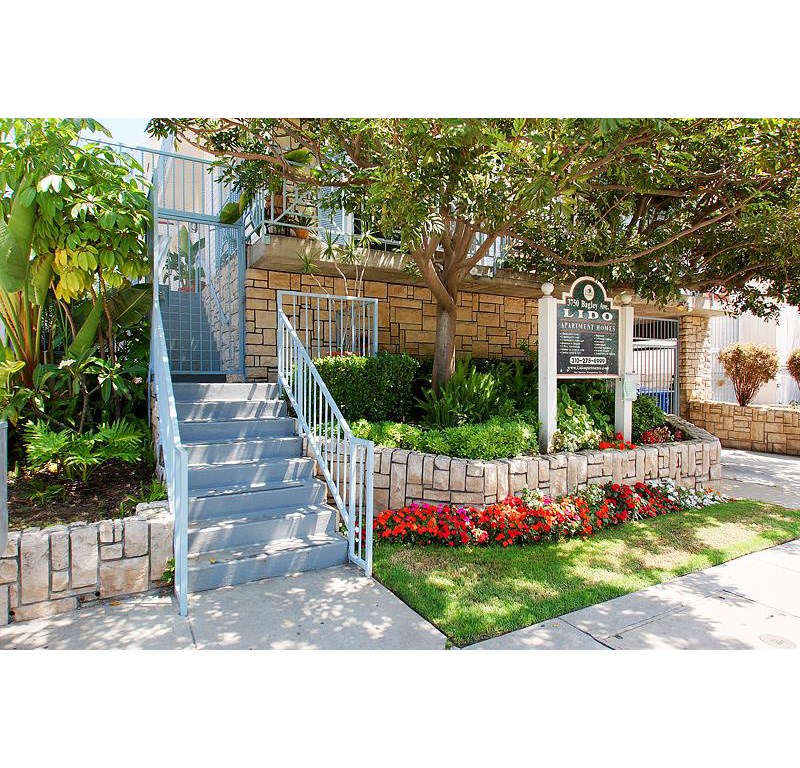 a staircase in front of a house with a sign