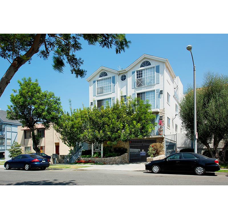 two cars parked in front of an apartment building