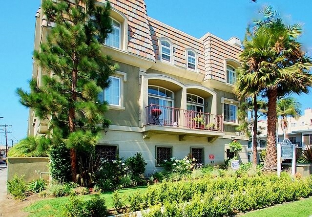 a large building with palm trees in front of it